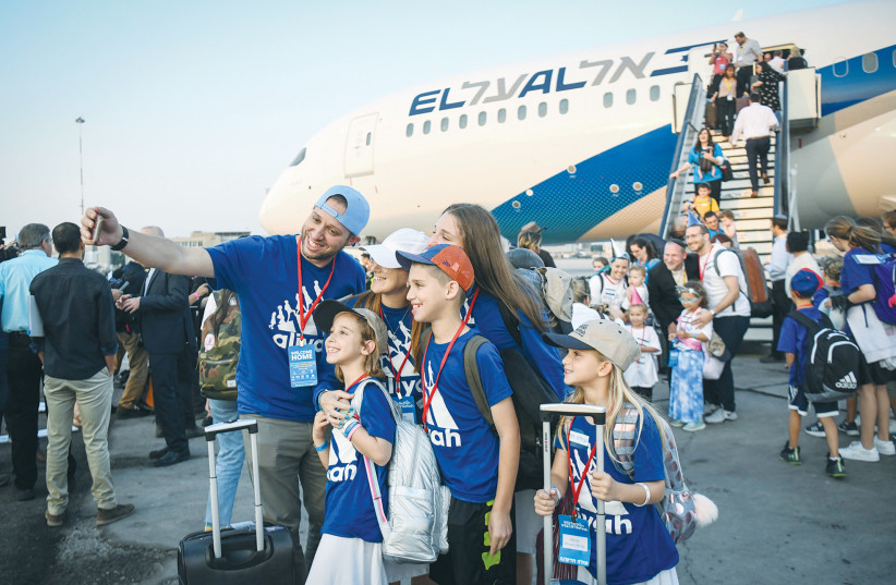 NEW IMMIGRANTS from North America arrive at Ben-Gurion Airport on a special El Al flight of the Nefesh B’Nefesh organization. Why do Jews from around the world, living comfortably in their birthplaces, leave everything they know and move to Israel? (credit: FLASH90) NEW IMMIGRANTS from North America arrive at Ben-Gurion Airport on a special El Al flight of the Nefesh B’Nefesh organization. Why do Jews from around the world, living comfortably in their birthplaces, leave everything they know and move to Israel? (credit: FLASH90)