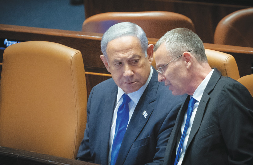 JUSTICE MINISTER Yariv Levin speaks with Prime Minister Benjamin Netanyahu during the voting in the Knesset plenum on Monday. (credit: YONATAN SINDEL/FLASH90) JUSTICE MINISTER Yariv Levin speaks with Prime Minister Benjamin Netanyahu during the voting in the Knesset plenum on Monday. (credit: YONATAN SINDEL/FLASH90)
