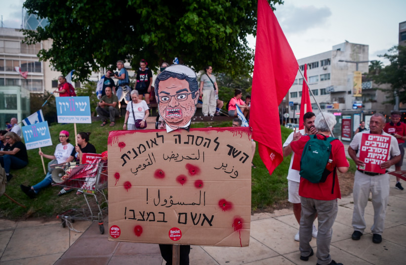 Demonstrator holding a sign reading ''the minister for nationalist incitement is responsible for the situation!'' at a protest against the violence in the Israeli Arab Community and the government's judicial overhaul, in Tel Aviv. August 26, 2023. (credit: AVSHALOM SASSONI/FLASH90) Demonstrator holding a sign reading ''the minister for nationalist incitement is responsible for the situation!'' at a protest against the violence in the Israeli Arab Community and the government's judicial overhaul, in Tel Aviv. August 26, 2023. (credit: AVSHALOM SASSONI/FLASH90)