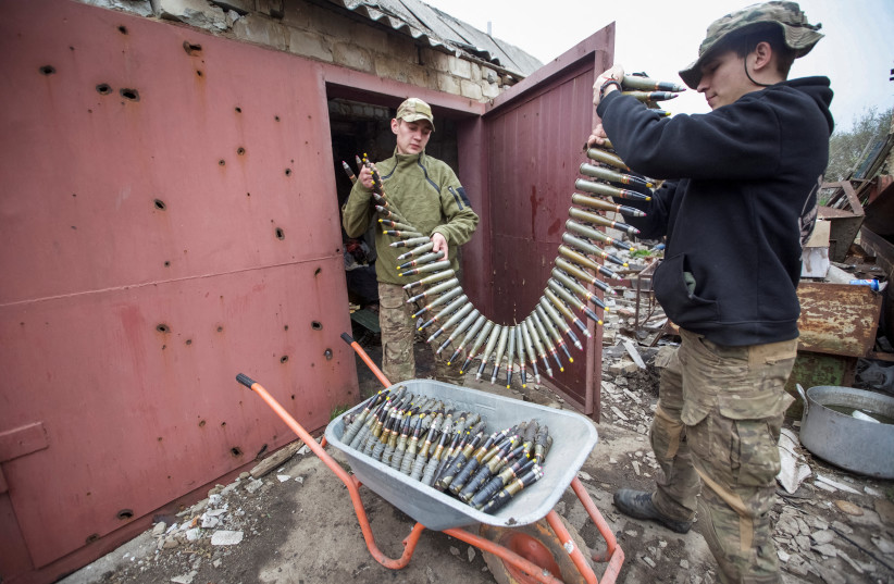 Ukrainian servicemen load ammunition for a machine gun at their position at a front line, amid Russia's attack on Ukraine, in Donetsk region, Ukraine May 5, 2023. (credit: REUTERS) Ukrainian servicemen load ammunition for a machine gun at their position at a front line, amid Russia's attack on Ukraine, in Donetsk region, Ukraine May 5, 2023. (credit: REUTERS)