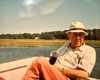 Sally Carton’s father in the boat he used during water rescues. Photo courtesy of the author.