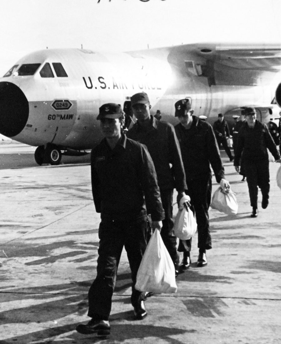 Crewmen of Pueblo (AGER-2) debark from a US Air Force VC-137C “Stratoliner” cargo transport after a flight from the Republic of Korea in December 1968. (Photo courtesy of the National Archives)