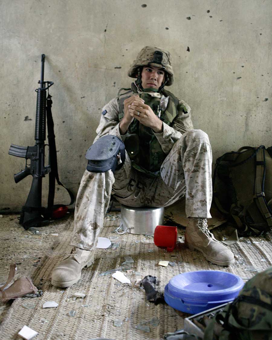 Combat photographer Trevor Gifts takes a breather inside a house days after arriving in Fallujah. The pad on his knee helped protect it “whenever I took a knee for fighting or taking pictures.”