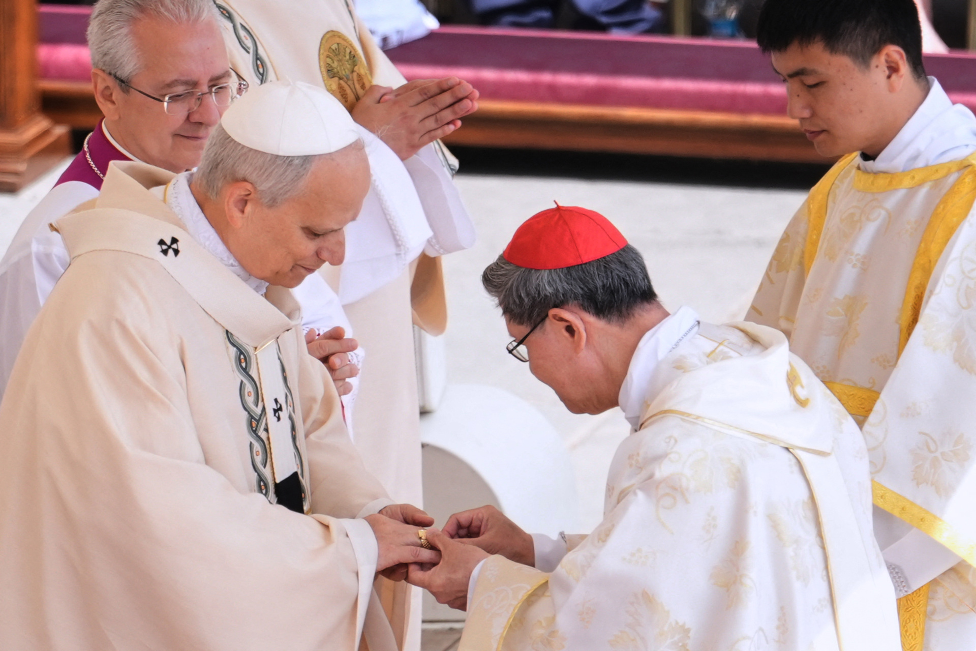 Filipino cardinal Luis Antonio Gokim Tagle puts the Fisherman's Ring on a finger of Pope Leo XIV during a mass for the beginning of his pontificate, in St Peter's square in The Vatican on May 18, 2025. (Photo by Jacquelyn Martin / POOL / AFP) (Photo by JACQUELYN MARTIN/POOL/AFP via Getty Images)