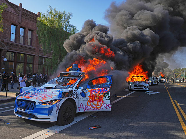 Multiple Waymo taxis burn near the Metropolitan Detention Center of downtown Los Angeles, Sunday, June 8, 2025, following last night's immigration raid protest. (AP Photo/Eric Thayer)