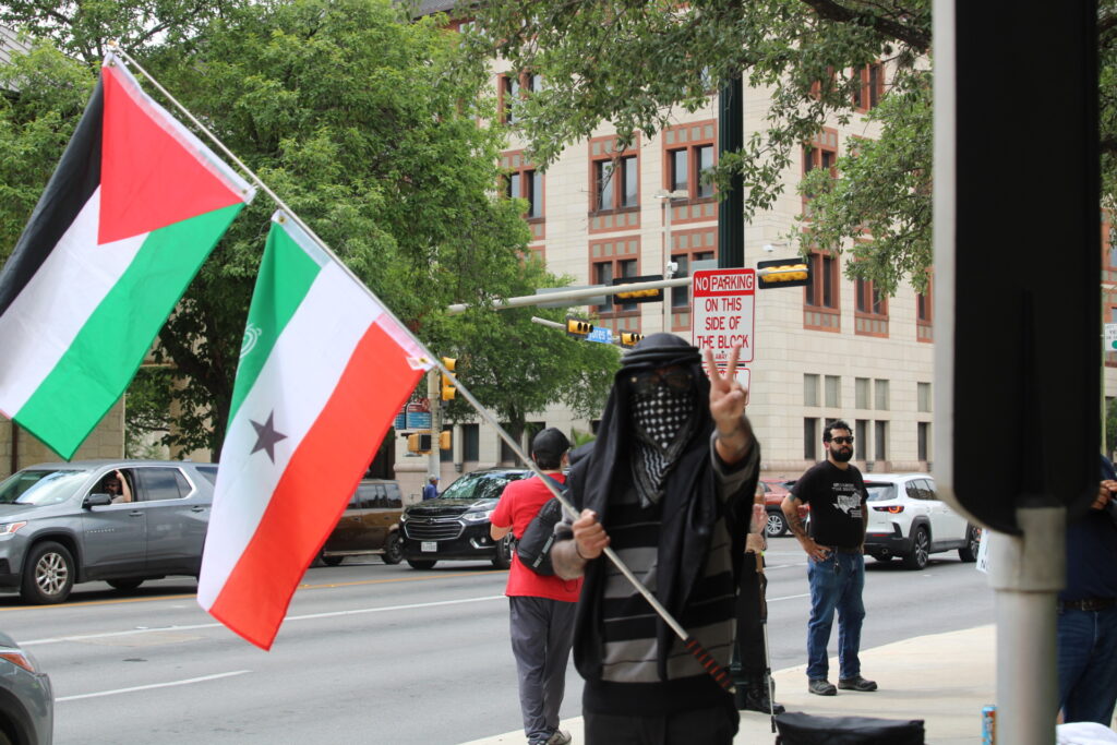 Protester waves Palestinian Flag at anti-ICE protest, photo by Randy Clark (Randy Clark/Breitbart Texas)