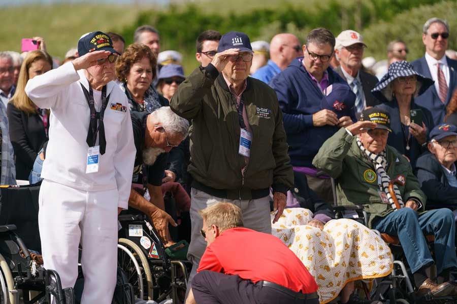 U.S. WWII veterans stand and salute during the playing of the National Anthem at the Utah Beach D-Day Ceremony at Utah Beach, Normandy, France, June 6, 2024.